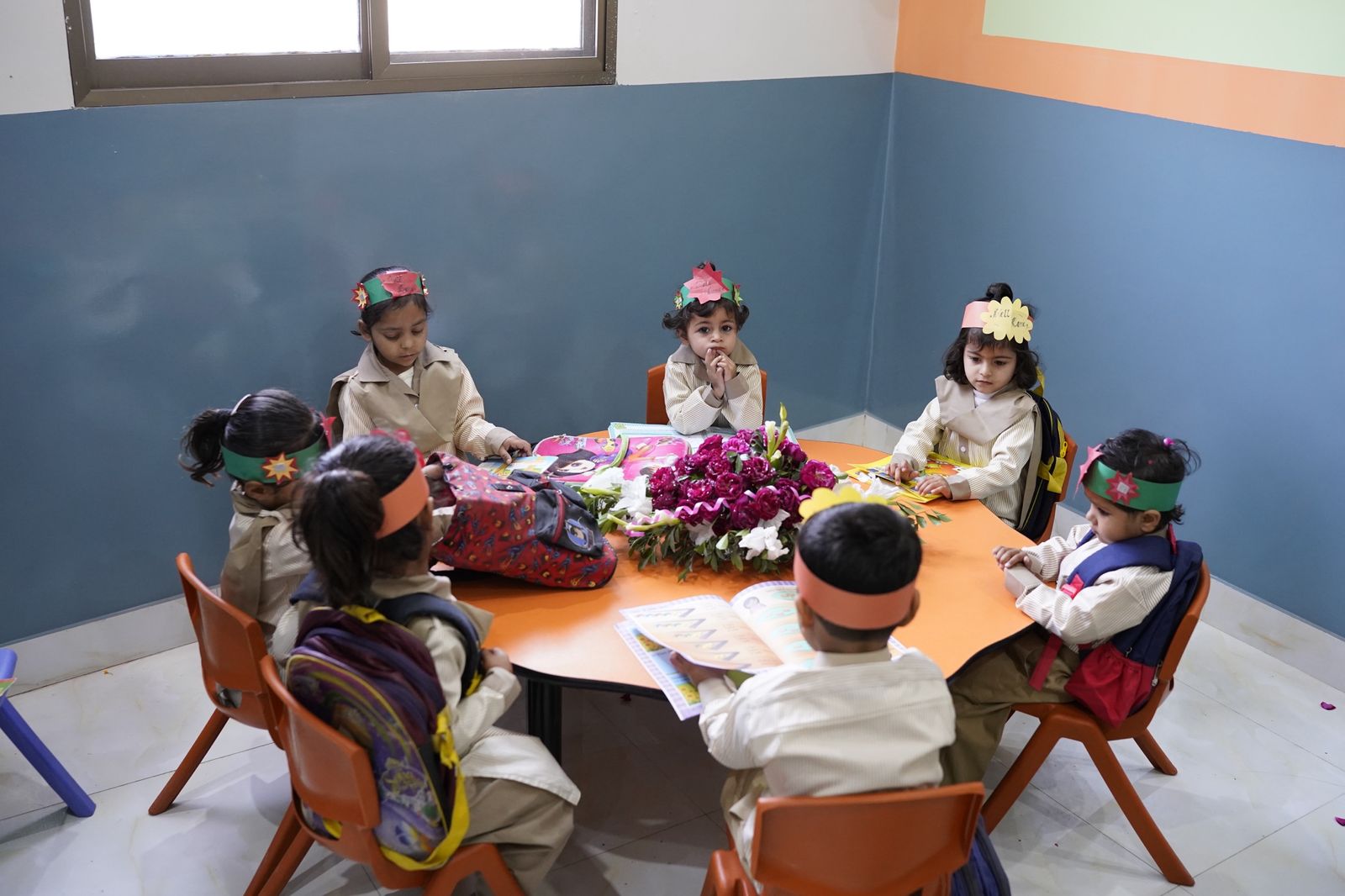 Early-years students around a classroom table
